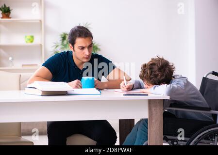 Father and disabled son in the education concept Stock Photo