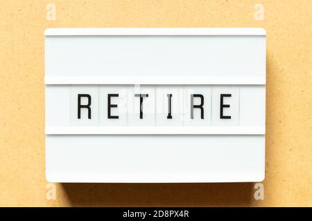 Lightbox with word retire on wood background Stock Photo