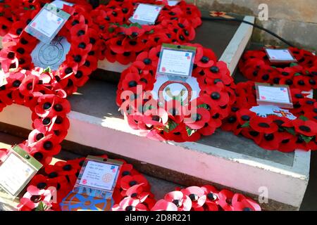 Small poppy wreaths are laid for Remembrance Day Stock Photo