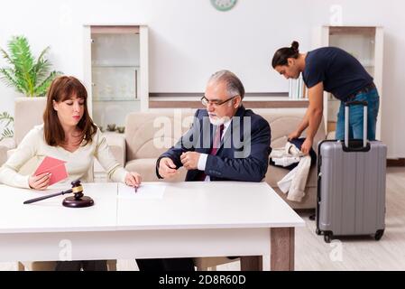 Old judge and young couple in divorcing concept Stock Photo