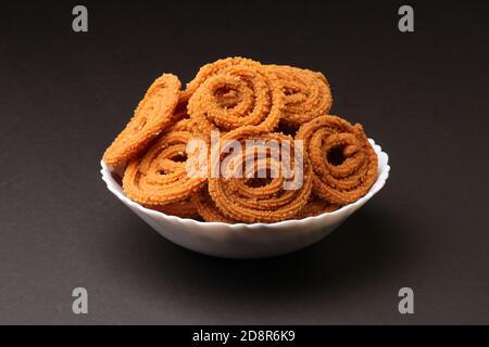 Indian Traditional Tea Time Snack Chakli, a deep fried snack, It is known as Chakali, Murukku, Muruku, Murkoo, Chakri. Stock Photo