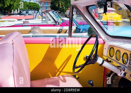 Inside view of a colorful vintage American car parked on a street in Havana city, Cuba. Cuban taxi. Stock Photo