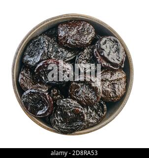 prunes in bowl with clipping path on a white isolated background Stock Photo