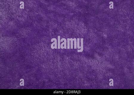 purple Abstract Artificial texture fur fabric, background, closeup. Fluffy material backdrop, kids toys faux fur. Stock Photo