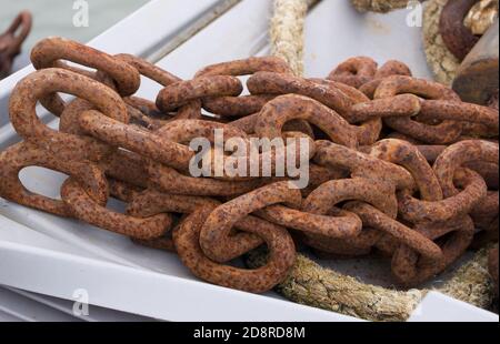 Pile of large old rusty nautical chain and rope together Stock Photo