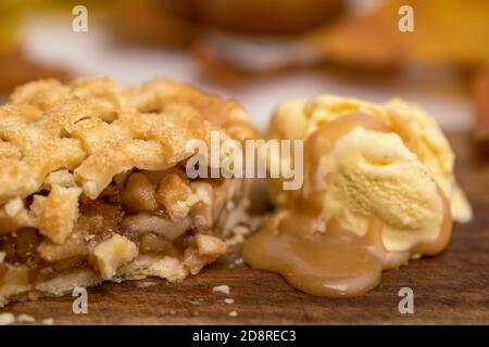 Autumn mini apple pie with lattice, ice cream, caramel sauce and leaves Stock Photo