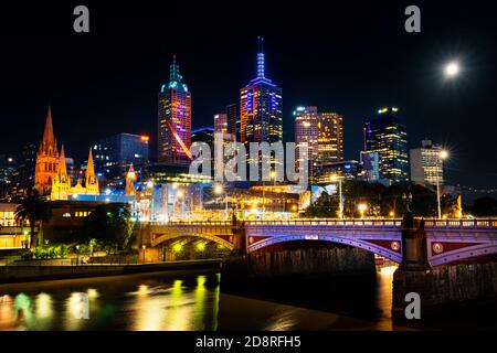 Colourful Melbourne at night under full moon. Stock Photo