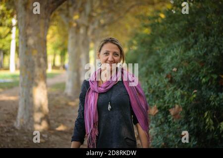 a woman under the falling yellow leaves Stock Photo