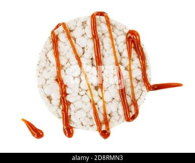 Round rice flatbread with salt caramel topping isolated  on white background. Stock Photo