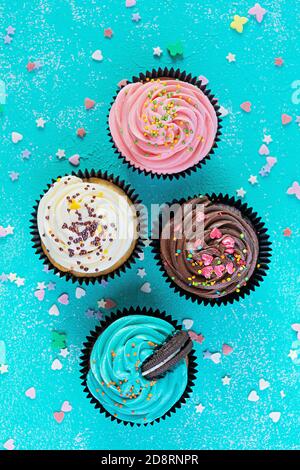Tasty colorful cupcakes isolated on blue background. Delicious cupcake Stock Photo