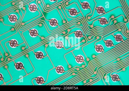 Futuristic looking circuit traces on green. No components, just the traces and contacts. This is from inside a computer keyboard. Stock Photo