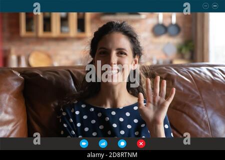 Head shot screen view smiling young woman waving hand Stock Photo