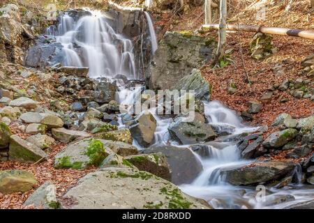 The waterfalls of Lago Santo Modenese in the autumn time on a sunny day, Emilia Romagna, Italy Stock Photo