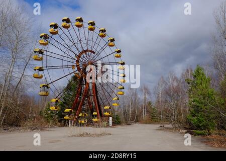 The famous Ferris wheel in an abandoned amusement park in Pripyat. Cloudy weather in the Chernobyl exclusion zone. Stock Photo
