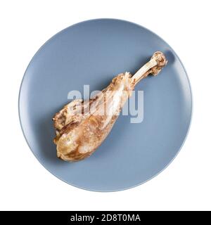 top view of single boiled turkey leg on blue plate isolated on white background Stock Photo
