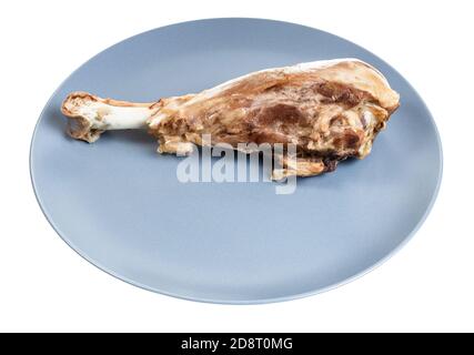 single boiled turkey drumstick on blue plate isolated on white background Stock Photo