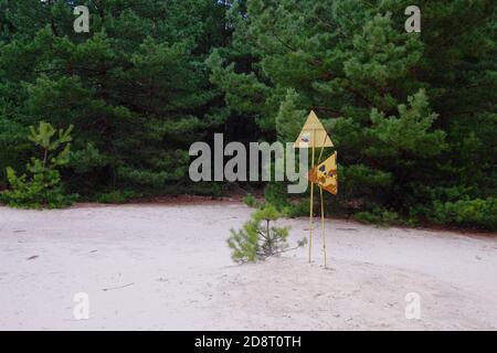 Radiation pollution sign near trees in the Chernobyl exclusion zone. Stock Photo