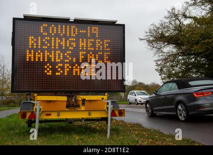 Taplow, Buckinghamshire, UK. 1st November, 2020. A public notice on the A4 Bath Road outside the Bishop Centre Retail Park in Taplow, Buckinghamshire warning of the rise in Covid-19 cases. Shoppers were out in force doing pre lockdown shopping as well as buying Christmas presents. England is going into a second lockdown from later this week following the big increase in positive Covid-19 cases. Credit: Maureen McLean/Alamy Live News Stock Photo