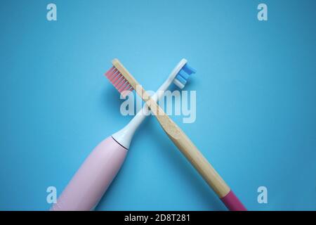 two ultrasonic electric toothbrushes on a blue background Stock Photo