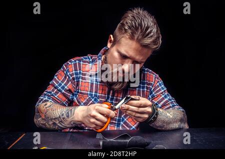 Leather master manufactures new product made of leather Stock Photo