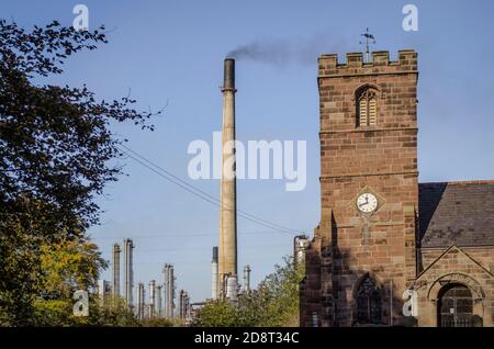 St Mary's Church and nearby Stanlow oil refinery, Thornton Le Moors, Cheshire. Stock Photo