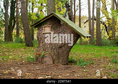 Small tree stump house in the woods Stock Photo