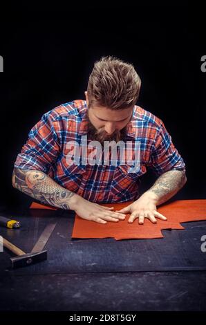 Craftsman creates a new leatherwork Stock Photo