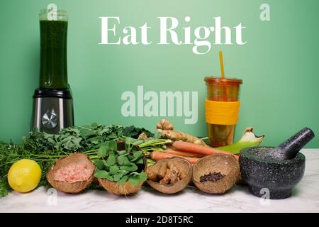 Healthy fresh vegetables, spices, and herbs on white and grey marble with text, Eat Right Stock Photo