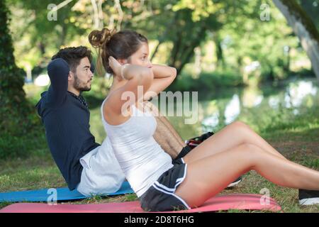 young couple training in beautiful park Stock Photo