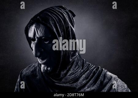 Portrait of a scary witch in hooded cloak Stock Photo - Alamy