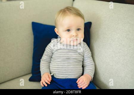 Portrait of baby boy sitting on the couch. Stock Photo