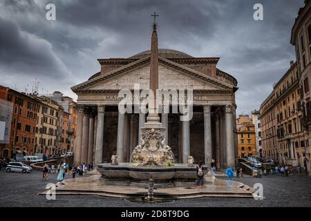 The Pantheon in city of Rome in Italy, stormy sky above ancient Roman temple from 113–125 AD and Fontana del Pantheon on Piazza della Rotonda Stock Photo