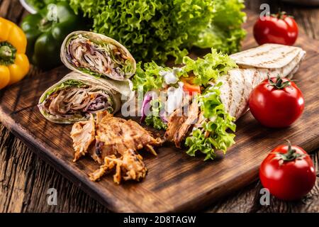 Various tortilla meals on a wooden chopping board Stock Photo