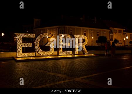 illuminated sign Egger in center of historic city, Northern Hungary Stock Photo