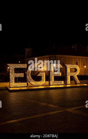 illuminated sign Egger in center of historic city, Northern Hungary Stock Photo