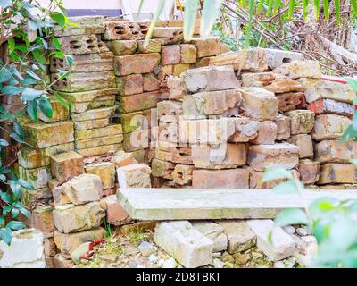 A pile of old used bricks stacked on the street Stock Photo