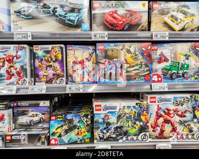 Puilboreau, France - October 14, 2020: Closeup of Man hand buying Avenger Marvel figurine Lego brand display for sell in french supermarket Stock Photo