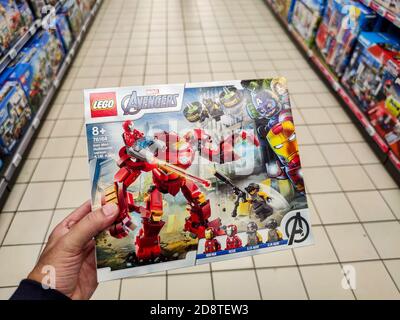 Puilboreau, France - October 14, 2020: Closeup of Man hand buying Avenger Marvel figurine Lego brand display for sell in french supermarket Stock Photo