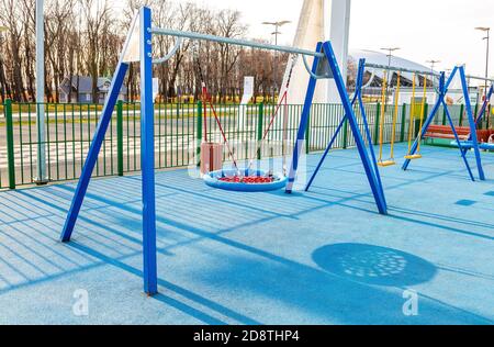 Samara, Russia - October 30, 2020: Children's playground for kids in new district with swing for play and rest. Recreation site with swing in city Stock Photo