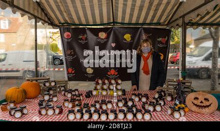 Homemade jam stall holder wearing face mask during Covid-19 pandemic, Haddington Farmer's market, East Lothian, Scotland, UK Stock Photo