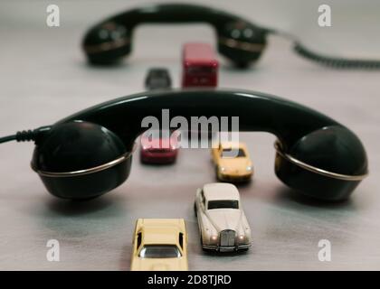 small vehicles (toys) pass under the telephone receivers Stock Photo