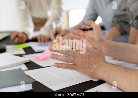 Close up young male employee gesturing, sharing project ideas. Stock Photo