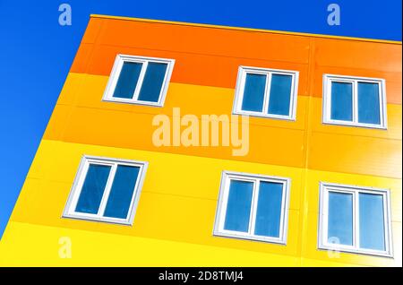 New bright colorful apartment building against blue sky background Stock Photo