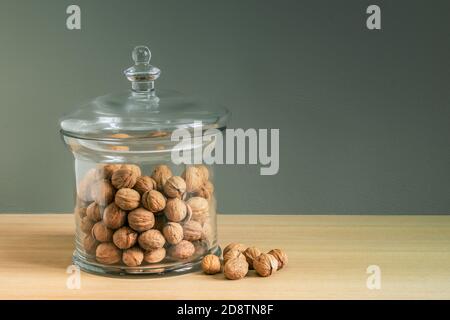 Dry walnuts in luxury glass candy jar as home decoration. Stock Photo