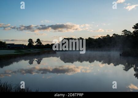 18th hole at Ballamor Golf Club in Southern New Jersey displays stunning fall sunrise amid morning fog. Stock Photo