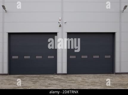 Close-up of automatic metal roller doors used in factory, warehouse, garage and industrial warehouse. Rolling gate or roller shutter used for factory, Stock Photo