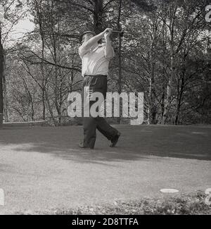 1960s, historical, a male golfer on an inland golf course driving the ball from a tee, England. UK/ Stock Photo