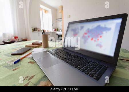 Distribution map Covid-19 on world map on computer in home office Stock Photo