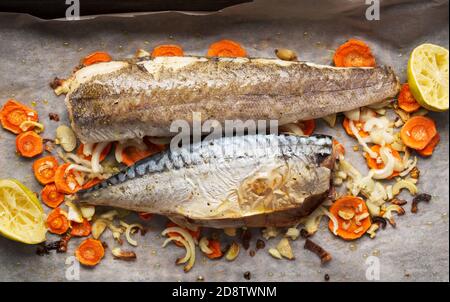 Fish with vegetables baked in oven, close up Stock Photo