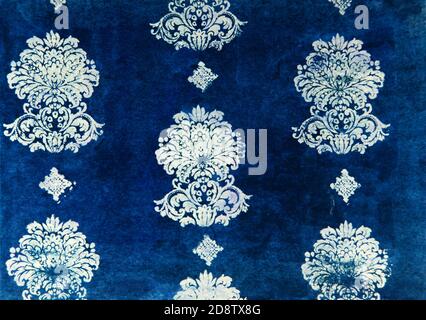 Stylized dark royal ornament stamped on paper against blue background Stock Photo
